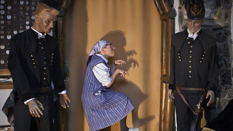 Bergbaumuseum, © Wiener Alpen/croy Eine Person posiert humorvoll zwischen zwei Bergmannspuppen in einem Museum.
