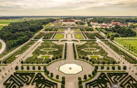 Luftaufnahme von Schloss Hof mit symmetrischen Gärten und Wegen.